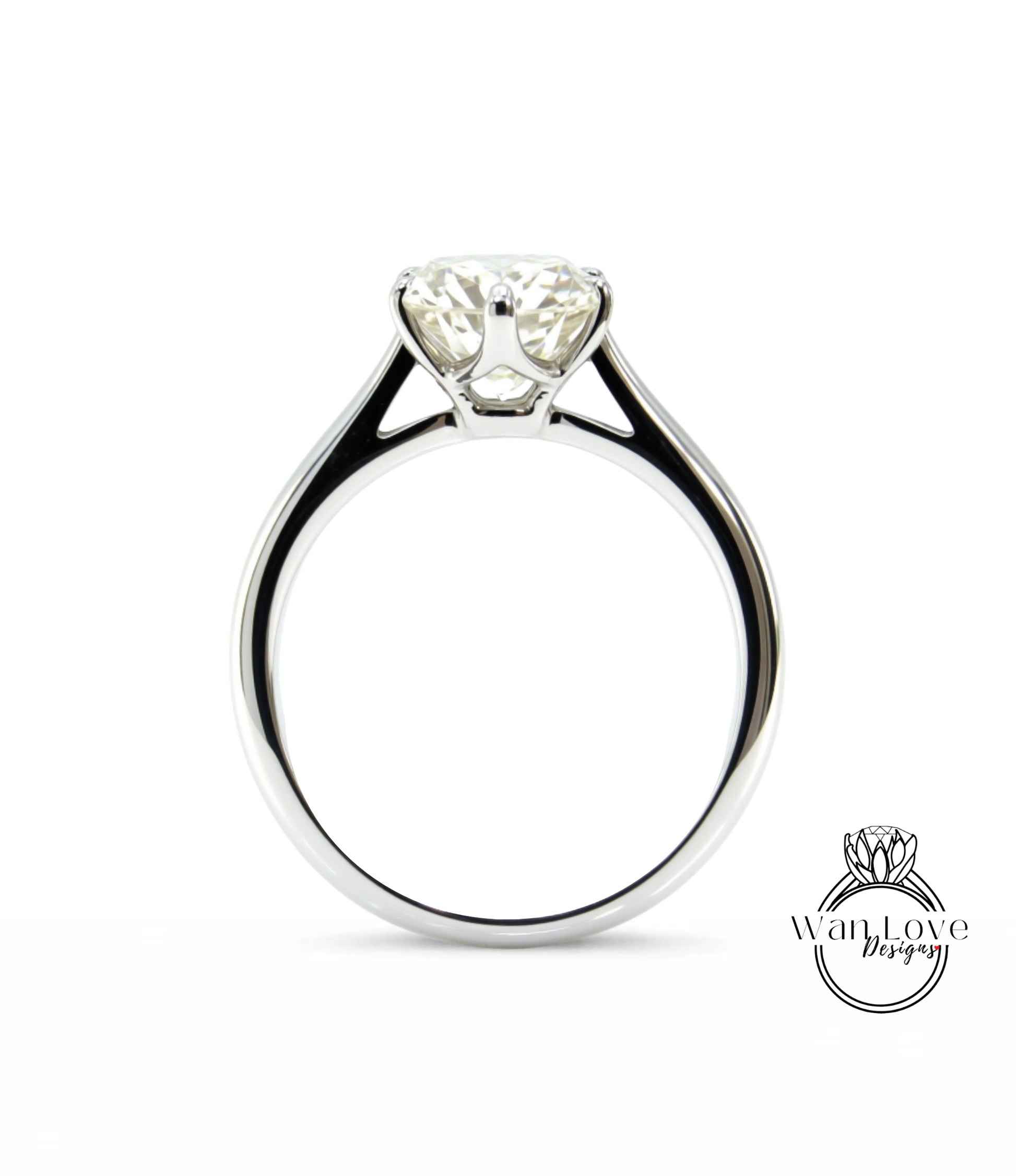 A close-up view of a silver engagement ring with a large, clear diamond set in the center.