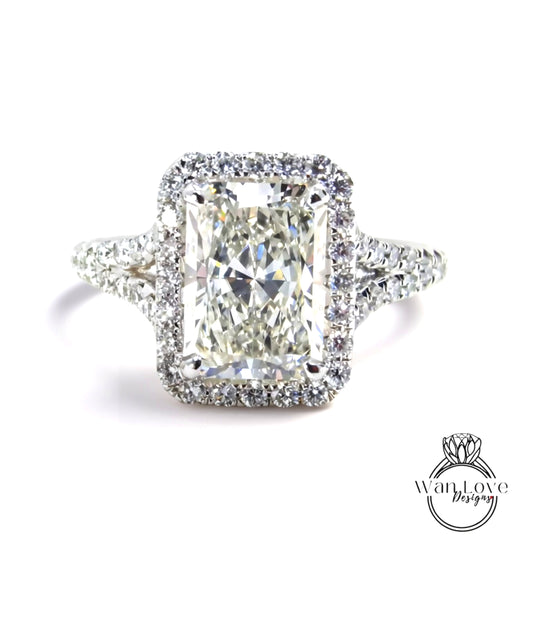 A stunning diamond engagement ring with a large, brilliant-cut diamond set in a halo of smaller diamonds, surrounded by a sparkling bezel.