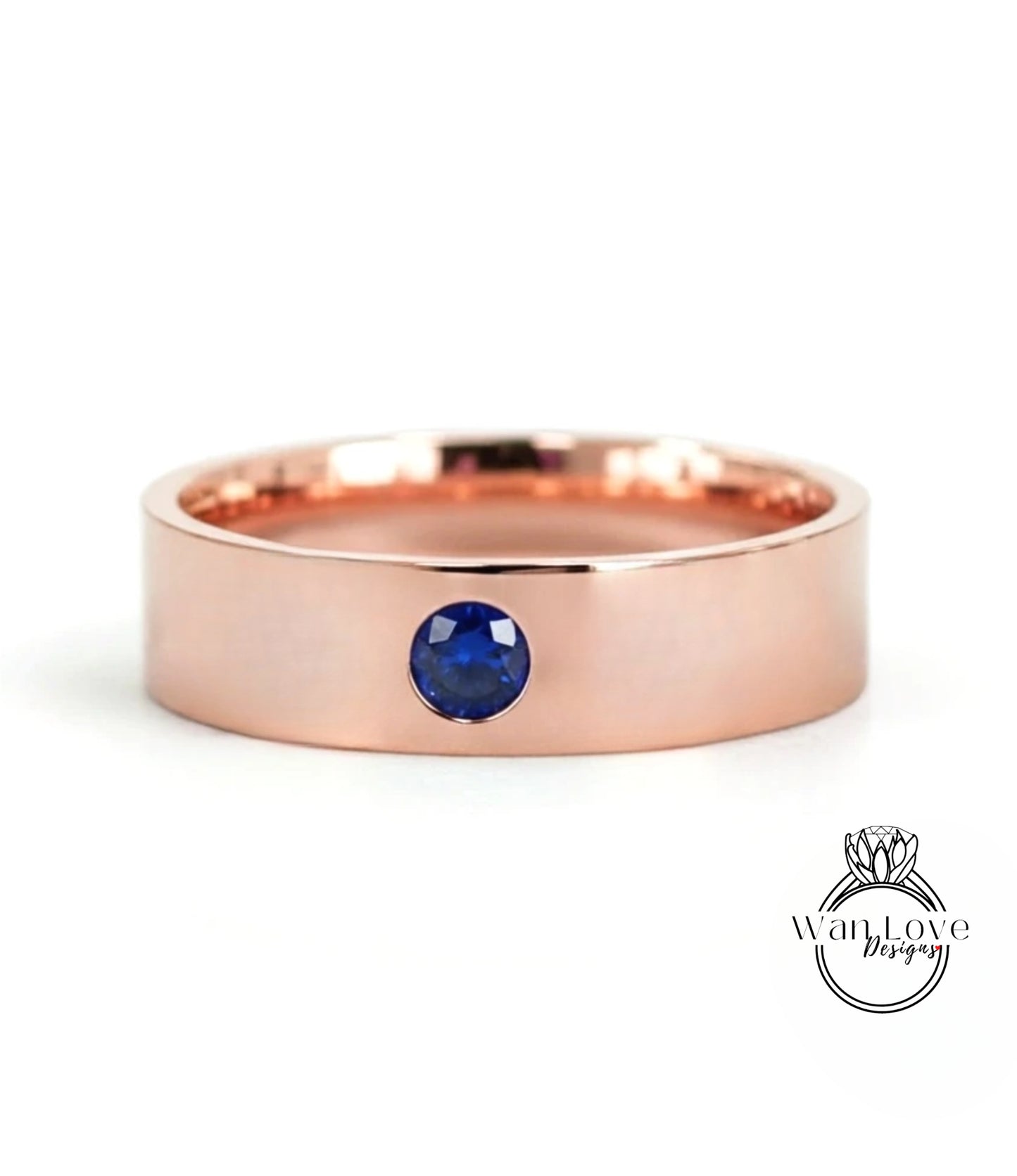 A rose gold band with a blue gemstone set in the center.