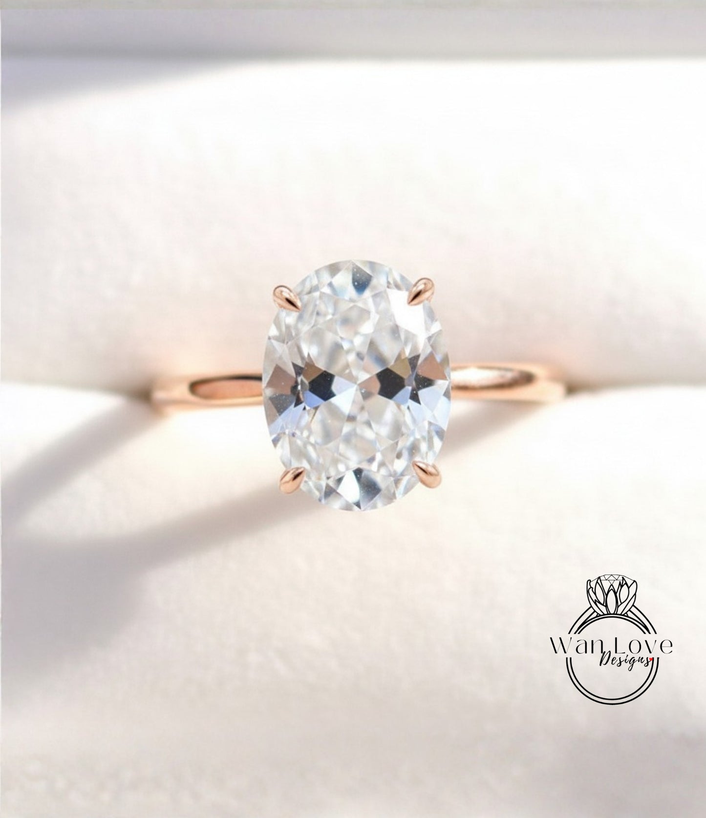 A close-up image of a diamond engagement ring with a large oval-shaped diamond set in a gold band.
