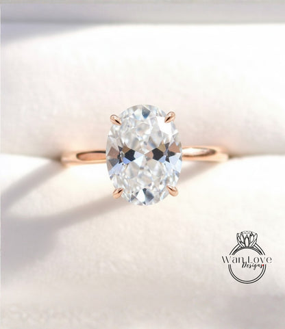 A close-up image of a diamond engagement ring with a large oval-shaped diamond set in a gold band.