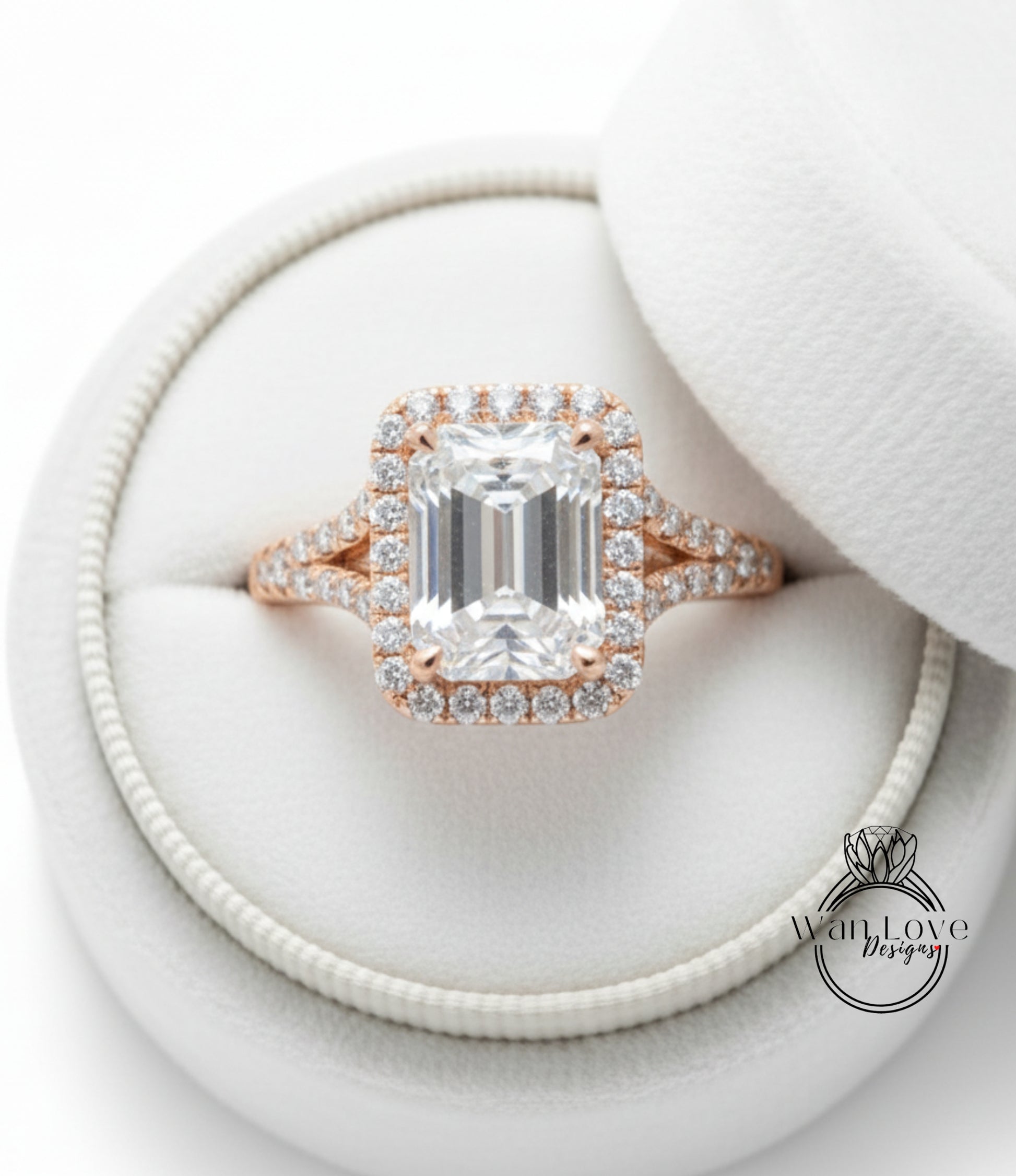 A large, clear diamond engagement ring with a halo of smaller diamonds around the center stone, displayed in a white jewelry box.