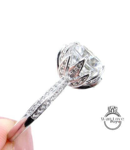 A close-up view of a diamond engagement ring with a large central diamond surrounded by smaller diamonds on the band.
