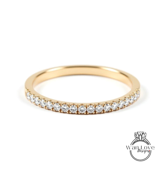 A gold band ring with a row of small diamonds set in it.