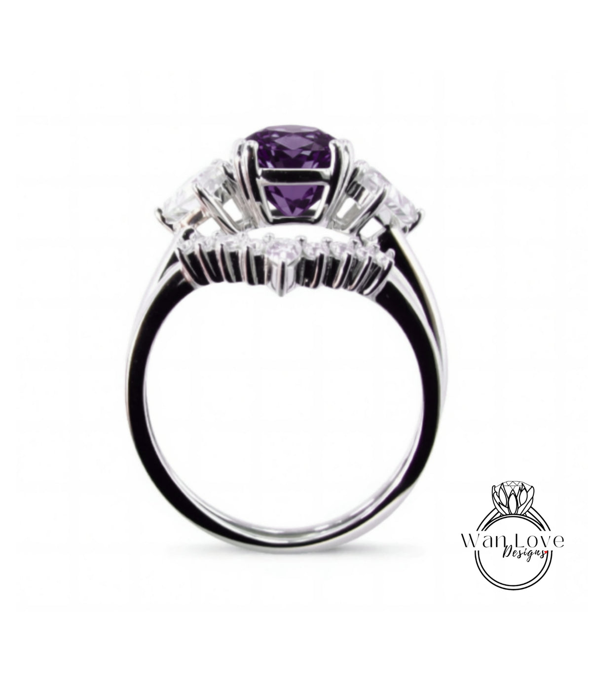 A silver ring with a large purple gemstone, surrounded by smaller diamonds, set in a halo of smaller diamonds.