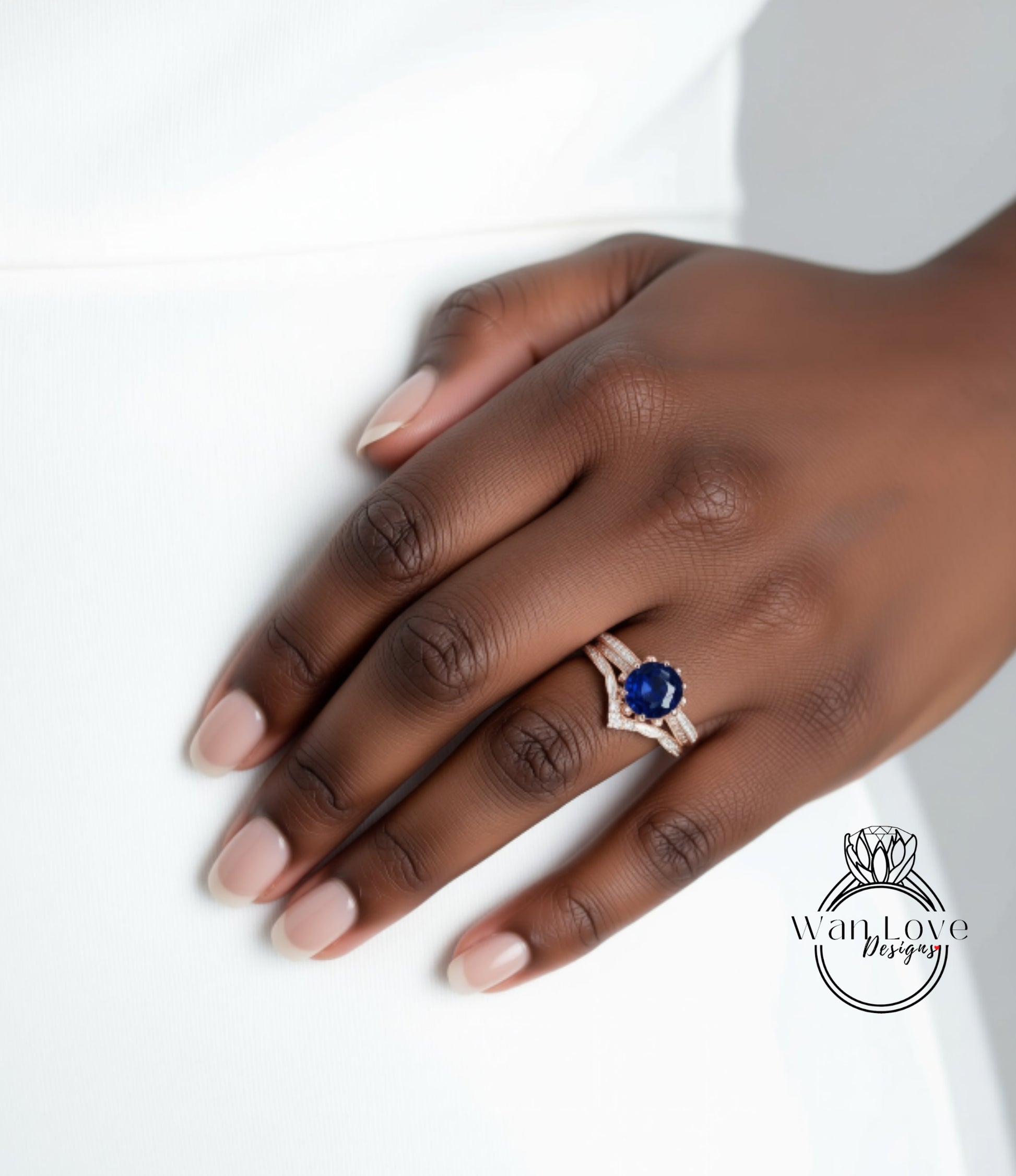 A close-up of a hand wearing a ring with a blue gemstone.