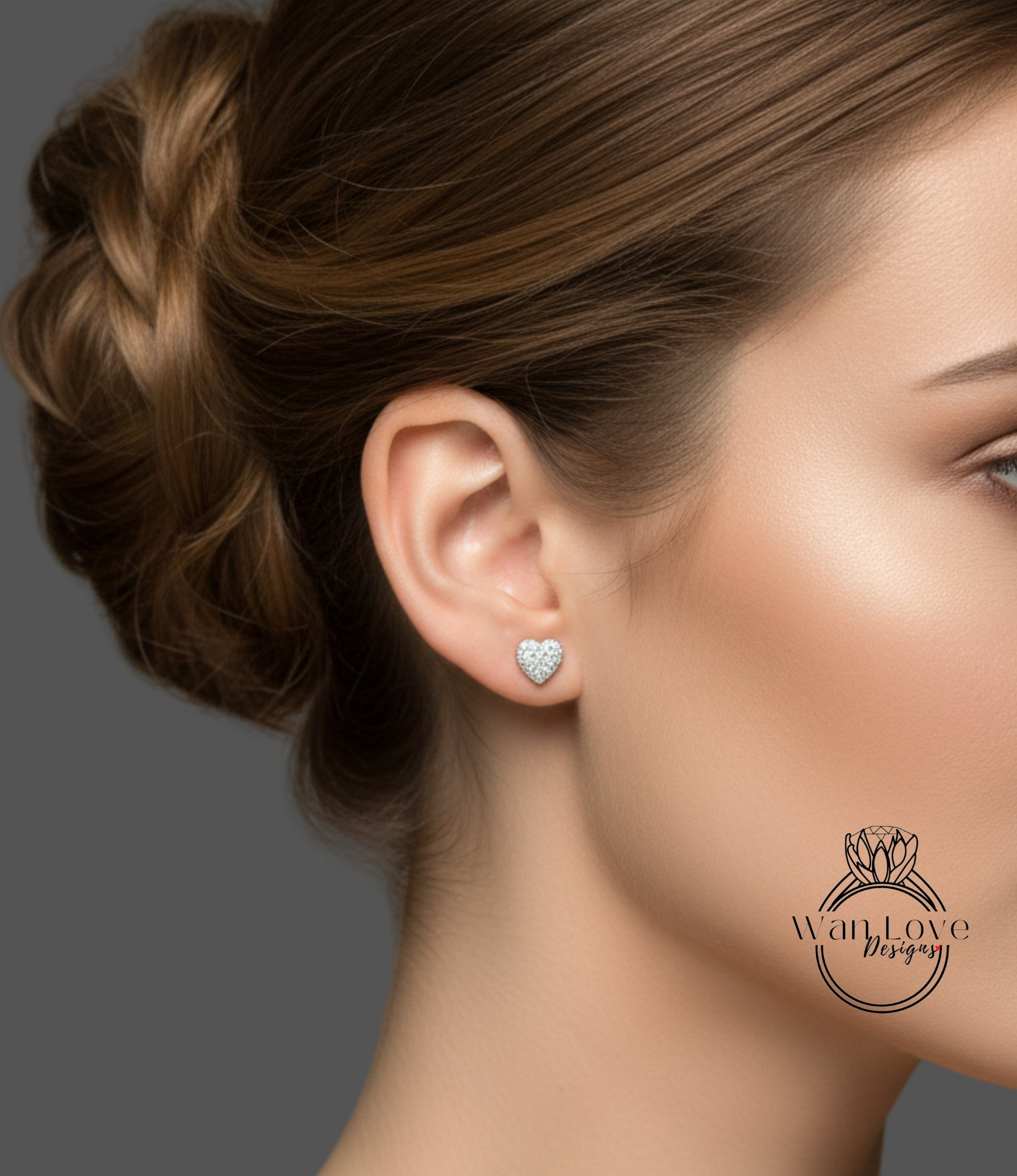 A close-up of a woman's face, focusing on her earrings and hair.