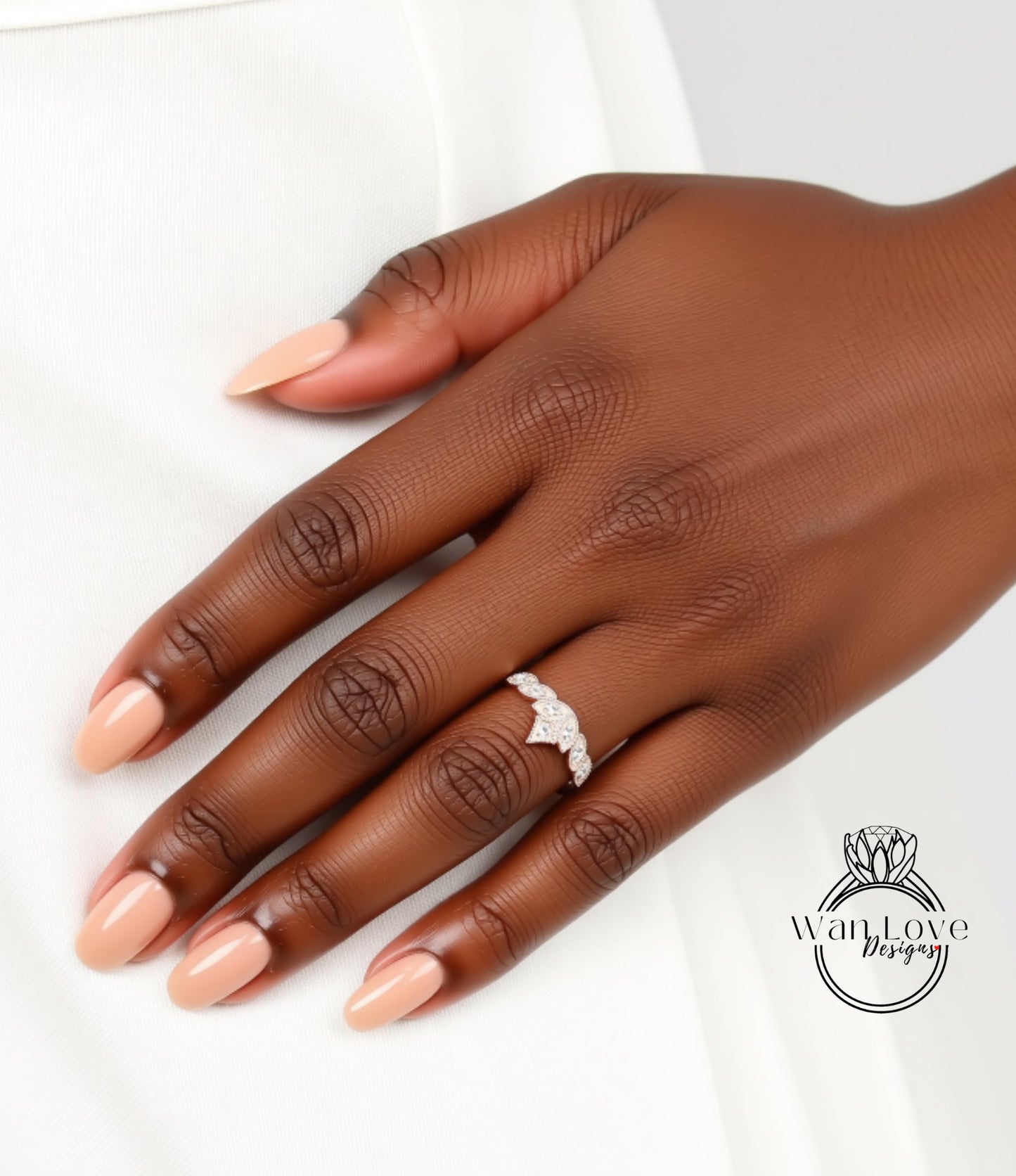 A close-up of a hand wearing a diamond engagement ring.