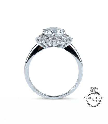 A silver ring with a large central diamond surrounded by smaller diamonds, showcasing the intricate design and craftsmanship of the piece.