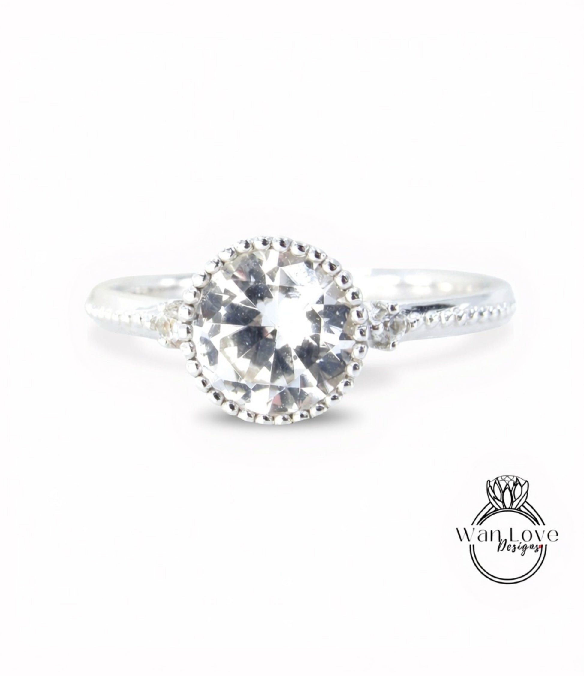 A close-up view of a silver ring with a large, clear gemstone set in the center.