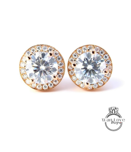 A pair of elegant earrings with large, clear gemstones set in a gold-toned metal frame.