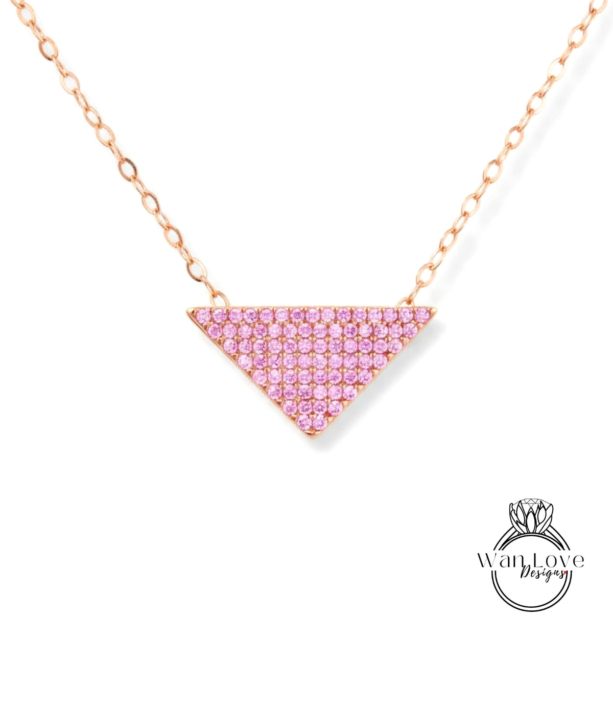 A necklace with a pink gemstone pendant in the shape of a triangle.