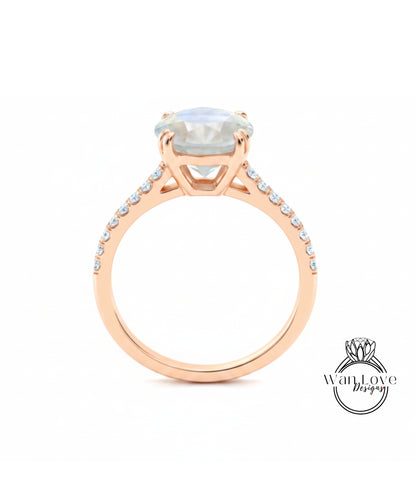 A gold ring with a large, clear gemstone set in the center, surrounded by smaller diamonds along the band.