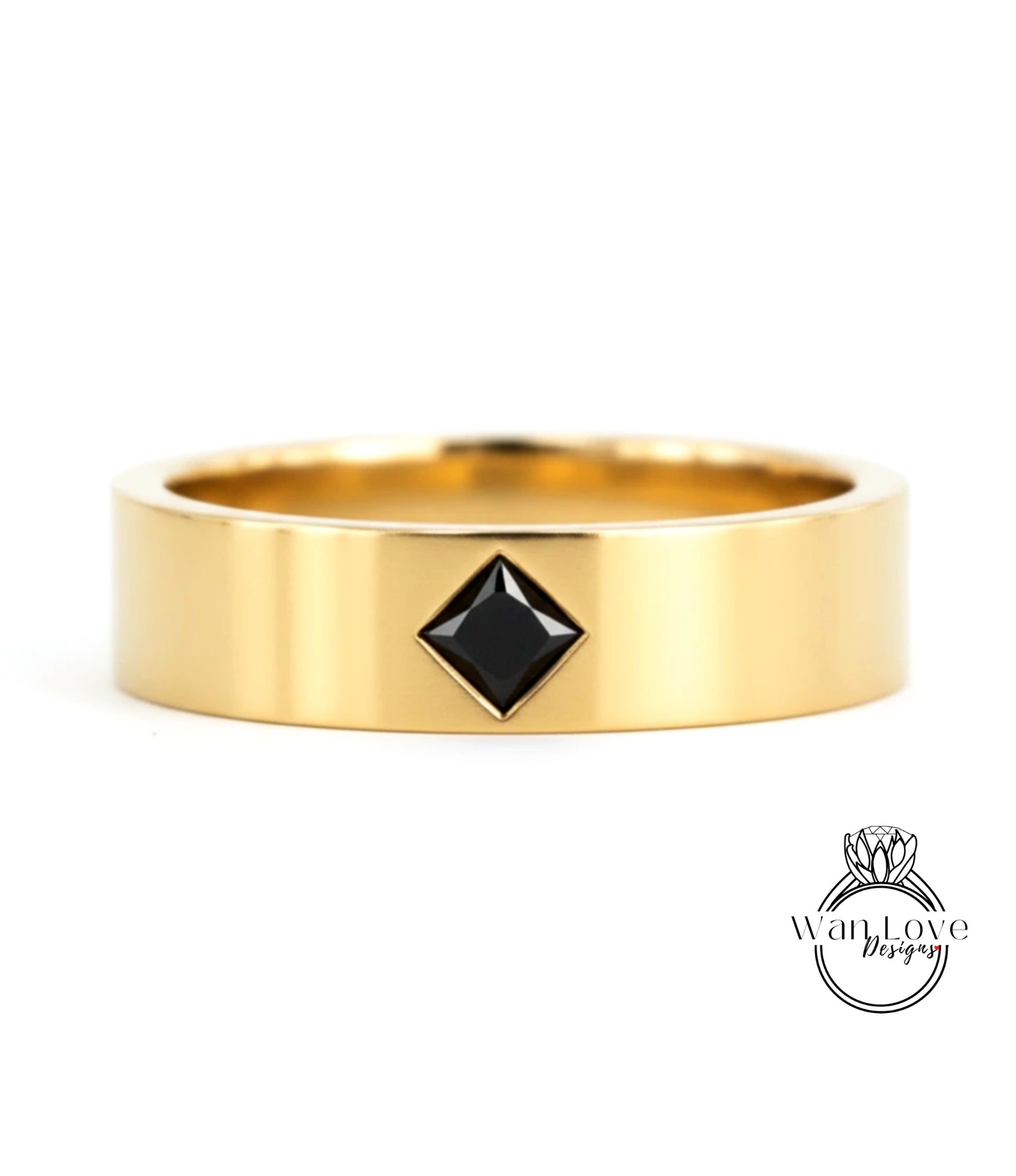 A gold ring with a black diamond-shaped gemstone set in the center.