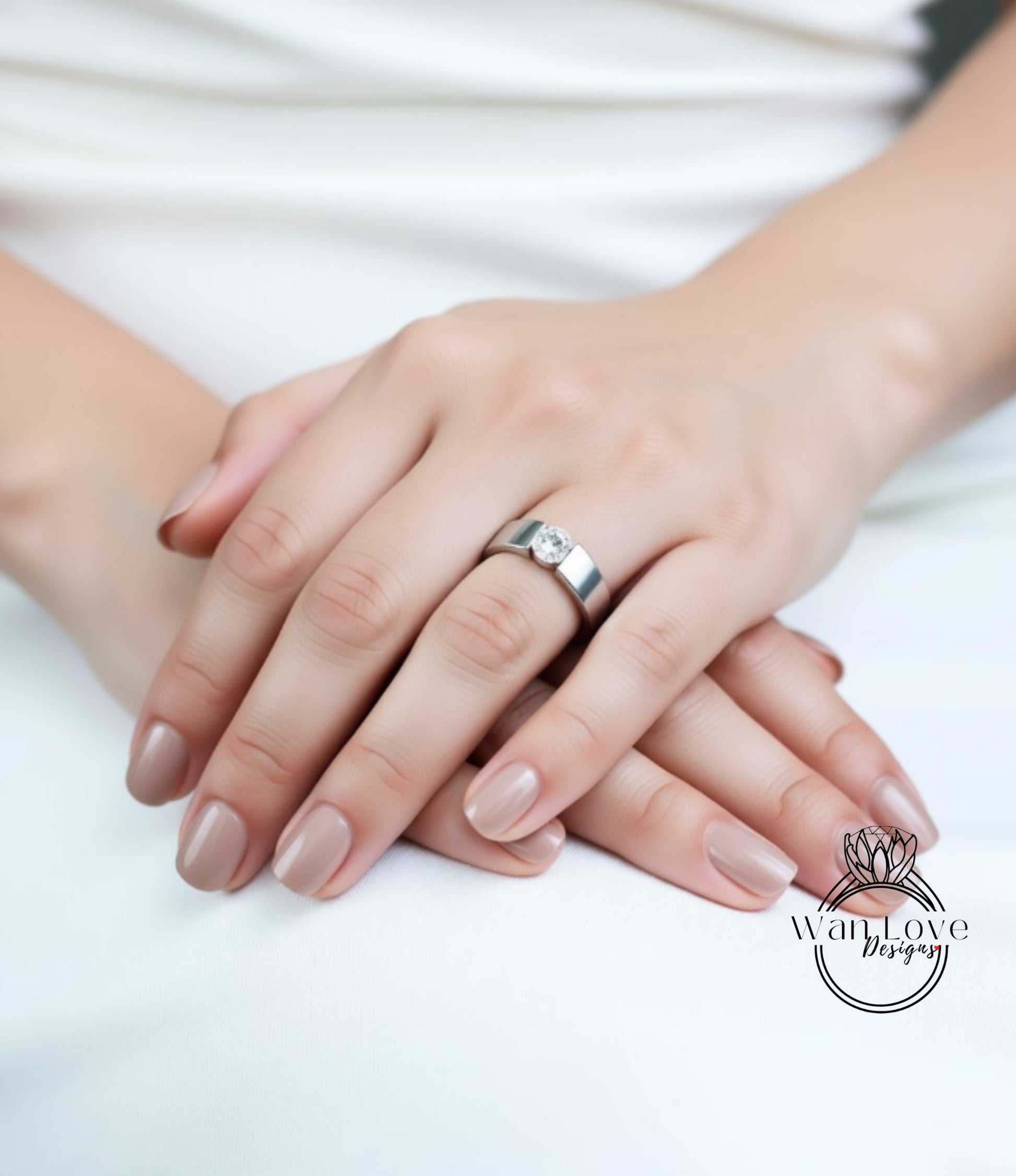 A close-up image of a person's hands wearing a silver ring.