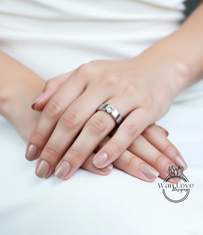 A close-up image of a person's hands wearing a silver ring.