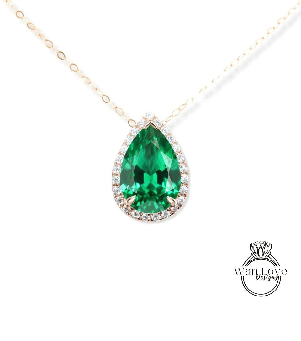 A close-up of a necklace with a large, green gemstone pendant.