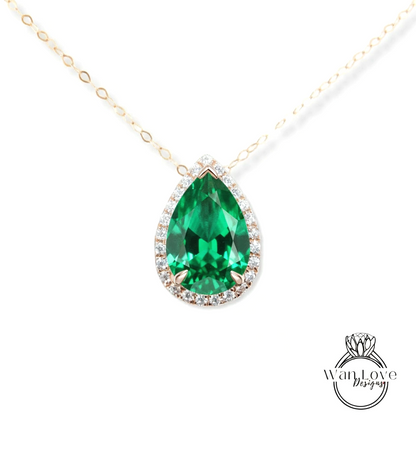 A close-up of a necklace with a large, green gemstone pendant.