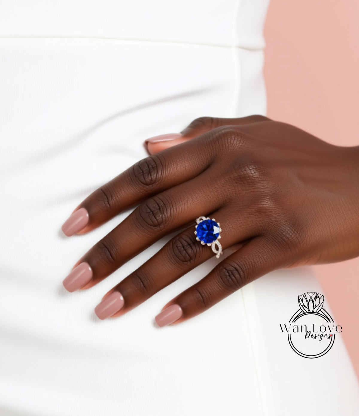 A close-up of a hand wearing a ring with a large blue gemstone.