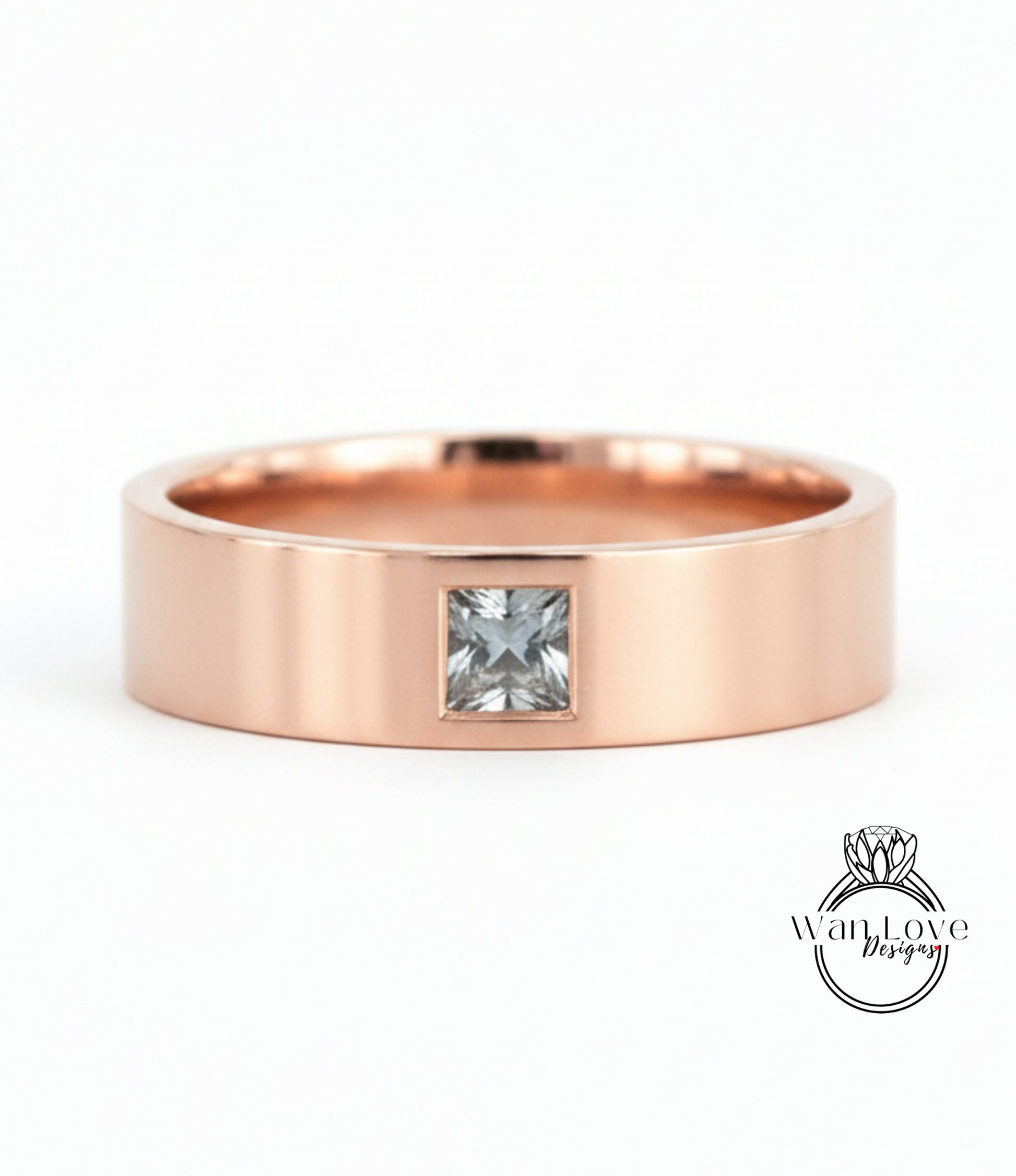 A rose gold band with a small square-cut diamond set in the center.