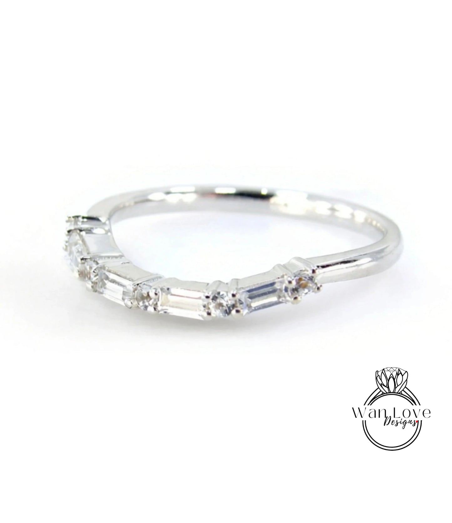 A silver ring with a row of small diamonds set in it.