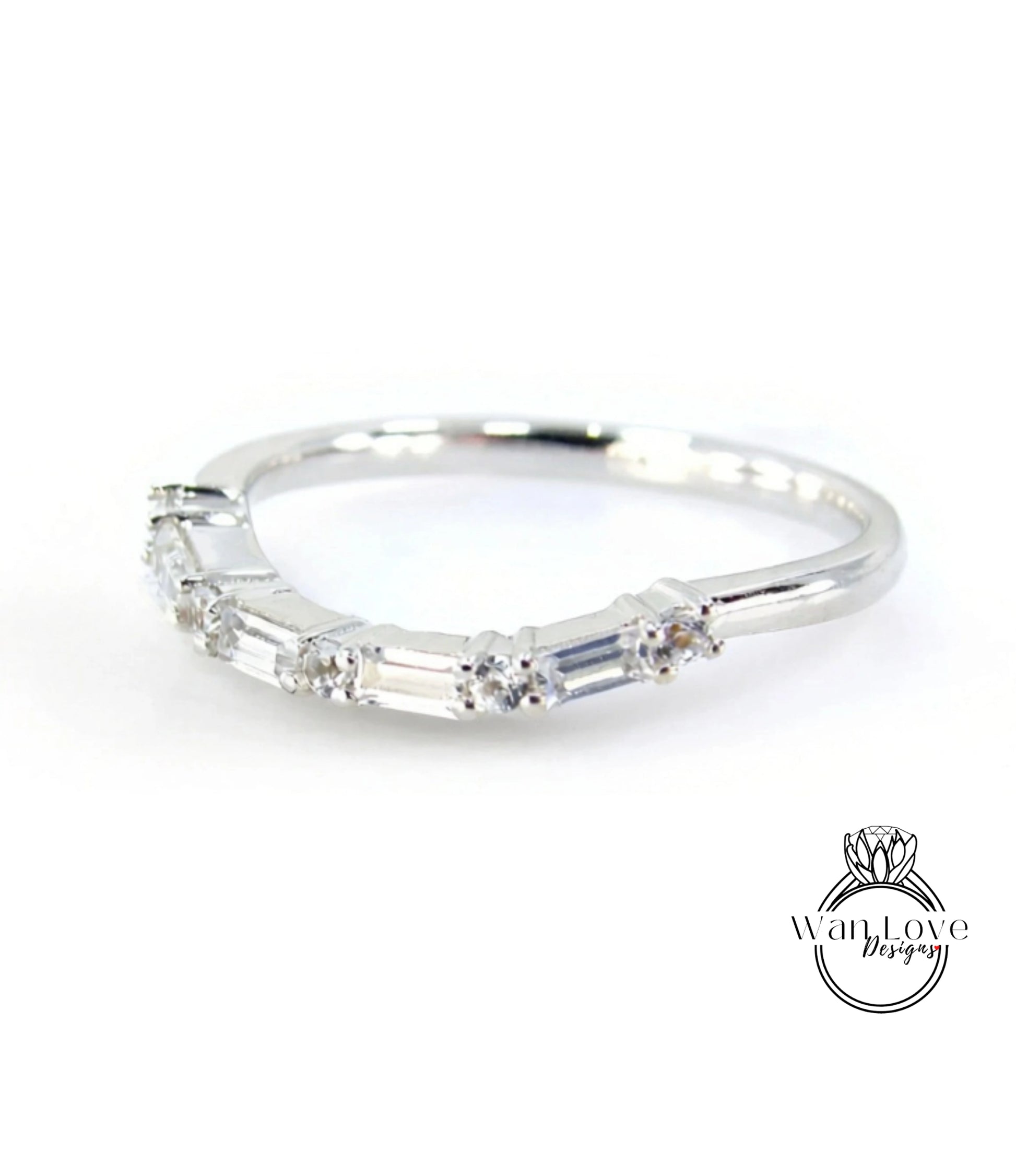A silver ring with a row of small diamonds set in it.