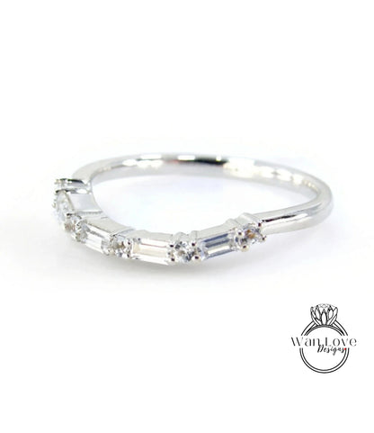 A silver ring with a row of small diamonds set in it.