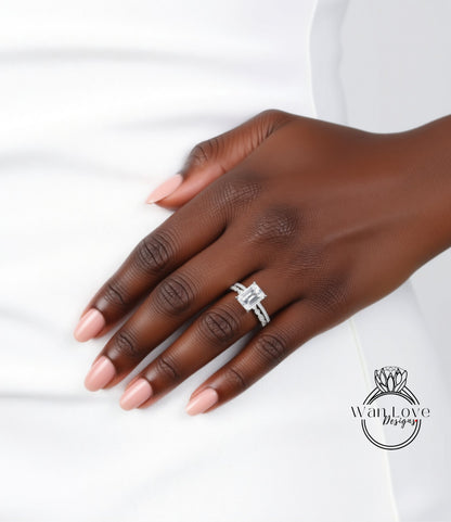 A close-up of a hand wearing a diamond engagement ring, resting on a white surface.