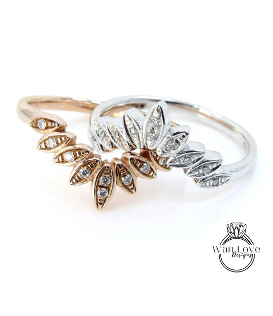 two rings with intricate designs, including a central ring with a large central flower-like element and smaller rings on either side.
