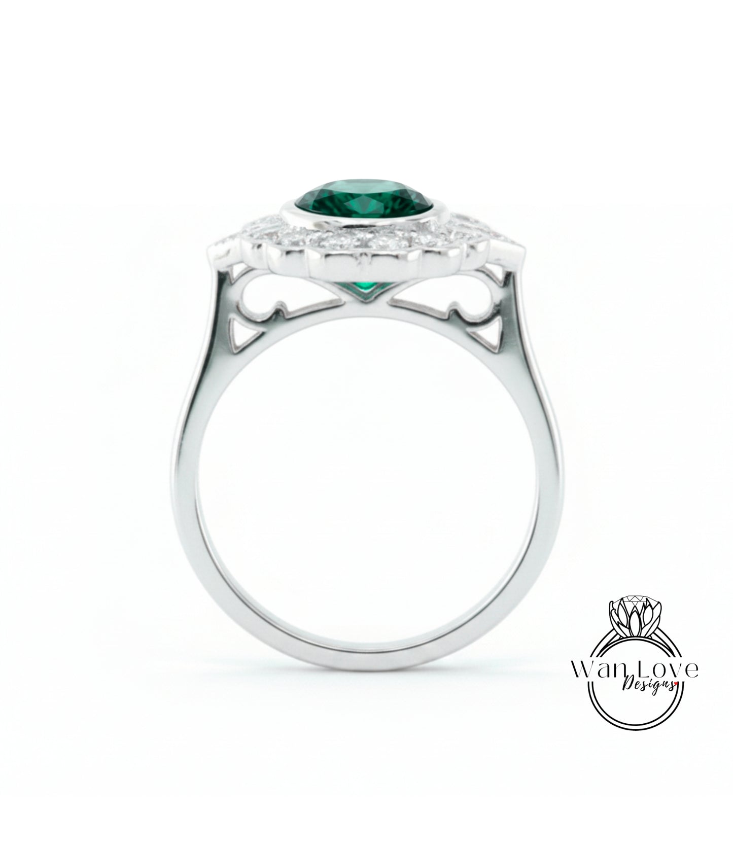 A silver ring with a large green gemstone set in the center, surrounded by smaller diamonds.