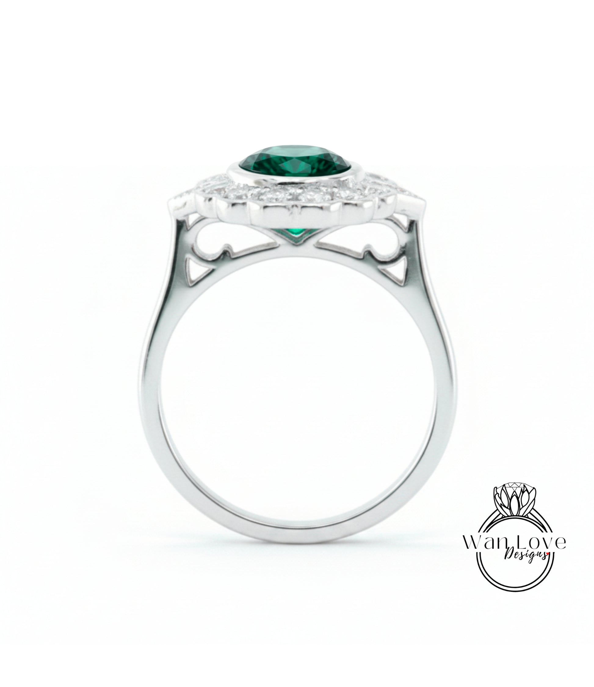 A silver ring with a large green gemstone set in the center, surrounded by smaller diamonds.
