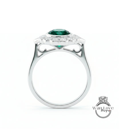 A silver ring with a large green gemstone set in the center, surrounded by smaller diamonds.