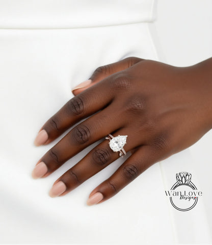 A close-up of a hand wearing a diamond engagement ring.