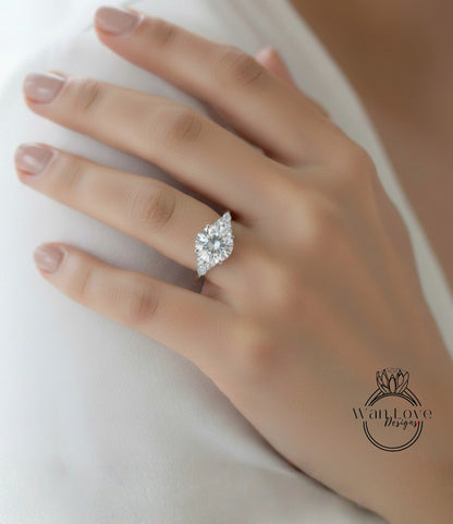 A close-up of a person's hand wearing a diamond engagement ring.