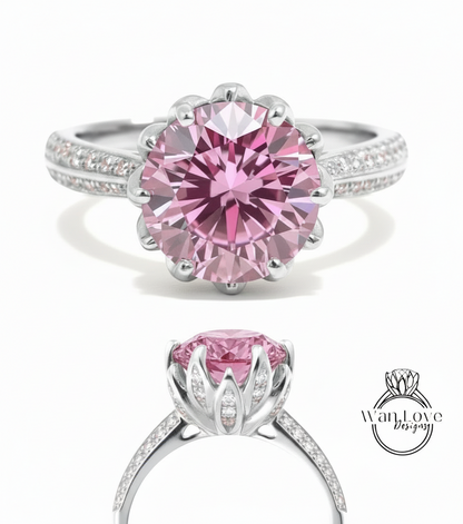A stunning pink diamond engagement ring with a large central diamond surrounded by smaller diamonds set in a silver band.
