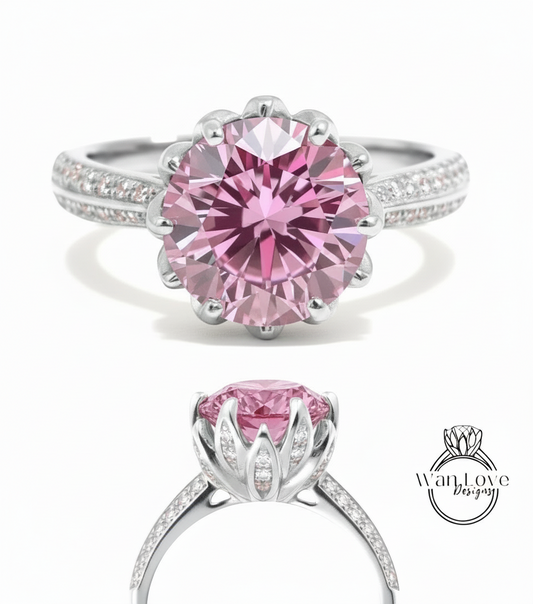 A stunning pink diamond engagement ring with a large central diamond surrounded by smaller diamonds set in a silver band.