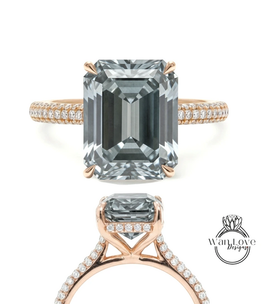 A large, rectangular-shaped diamond engagement ring with a gold band and small diamonds set in the band.