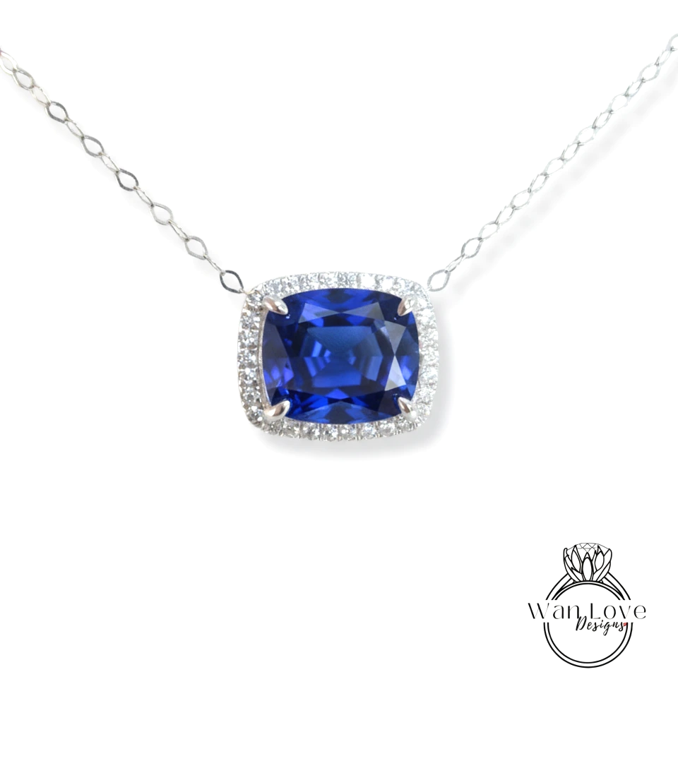 A necklace with a large blue gemstone, likely a sapphire, surrounded by a halo of smaller diamonds.