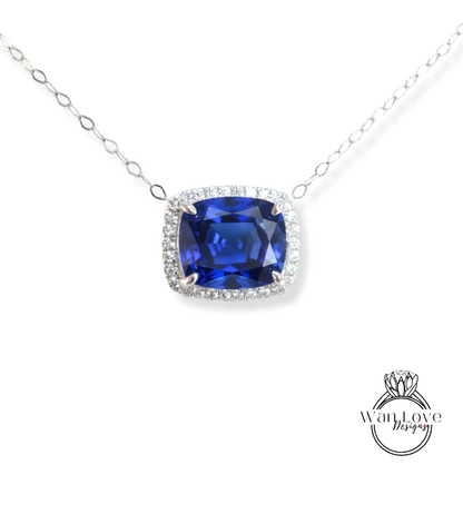A necklace with a large blue gemstone, likely a sapphire, surrounded by a halo of smaller diamonds.