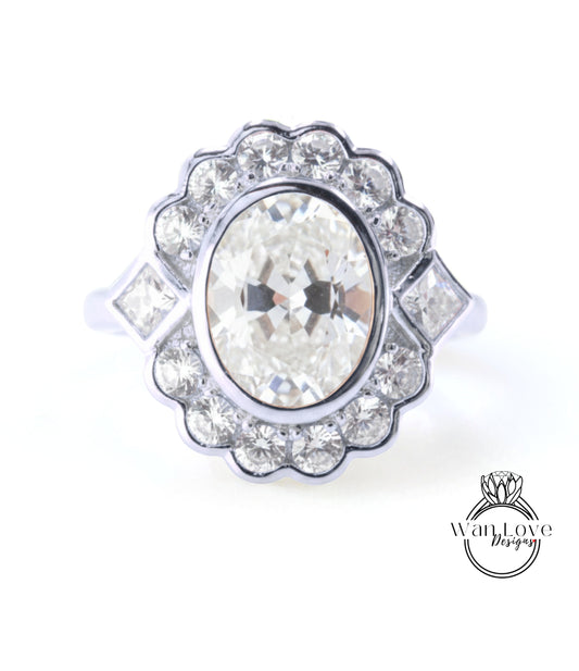 A stunning diamond engagement ring with a large oval-shaped diamond at the center, surrounded by smaller diamonds. The ring is set in a silver band, and the background is white.
