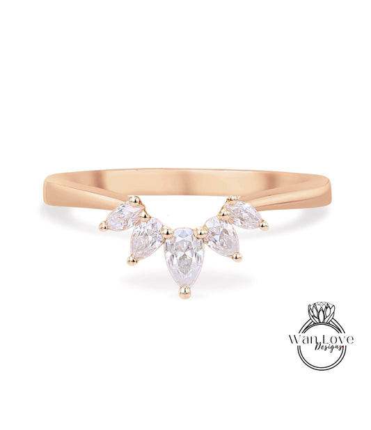 A gold ring with a large, clear gemstone set in the center, surrounded by smaller, clear gemstones.