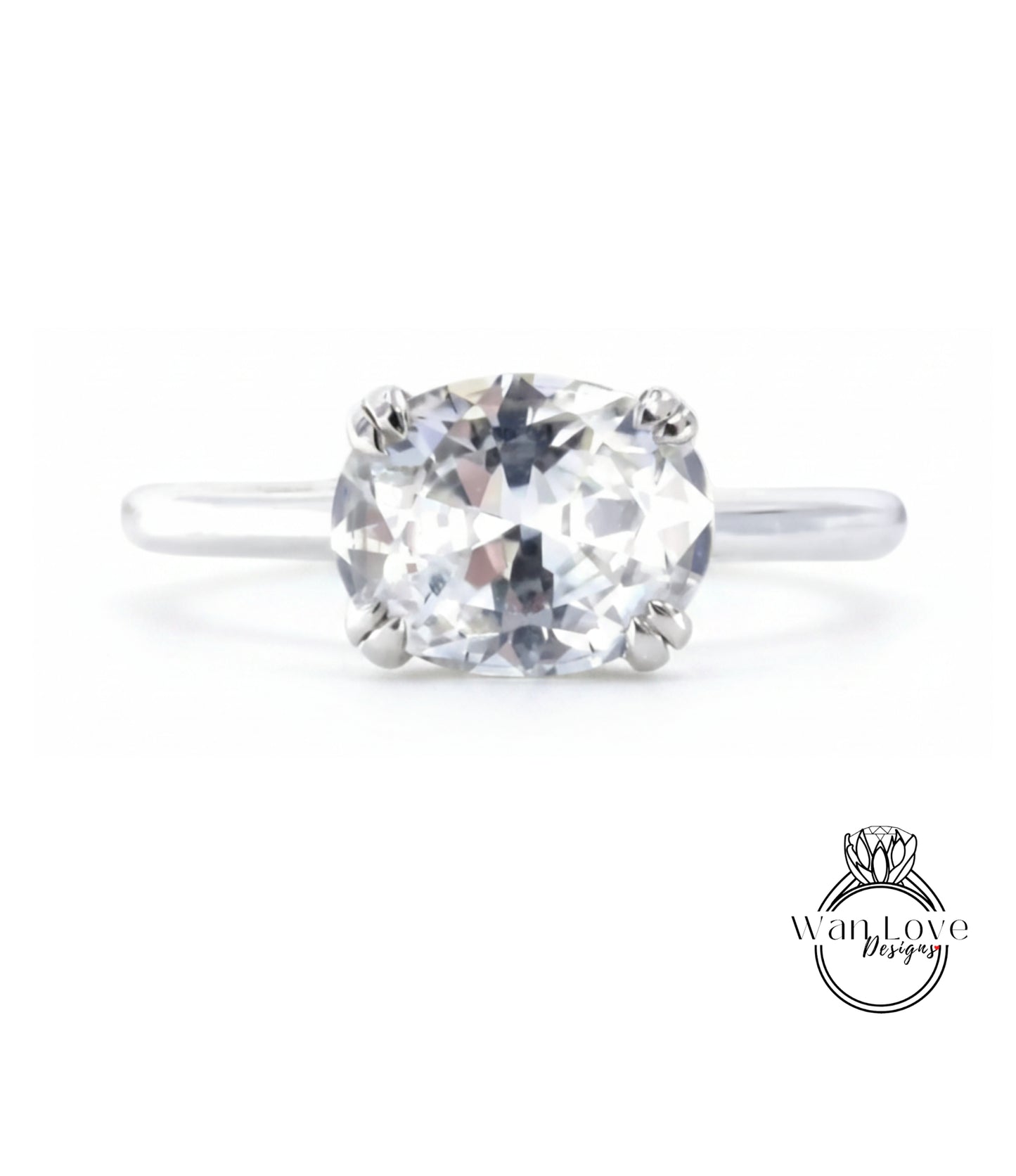 A close-up view of a diamond engagement ring with a large, clear gemstone set in a silver band.