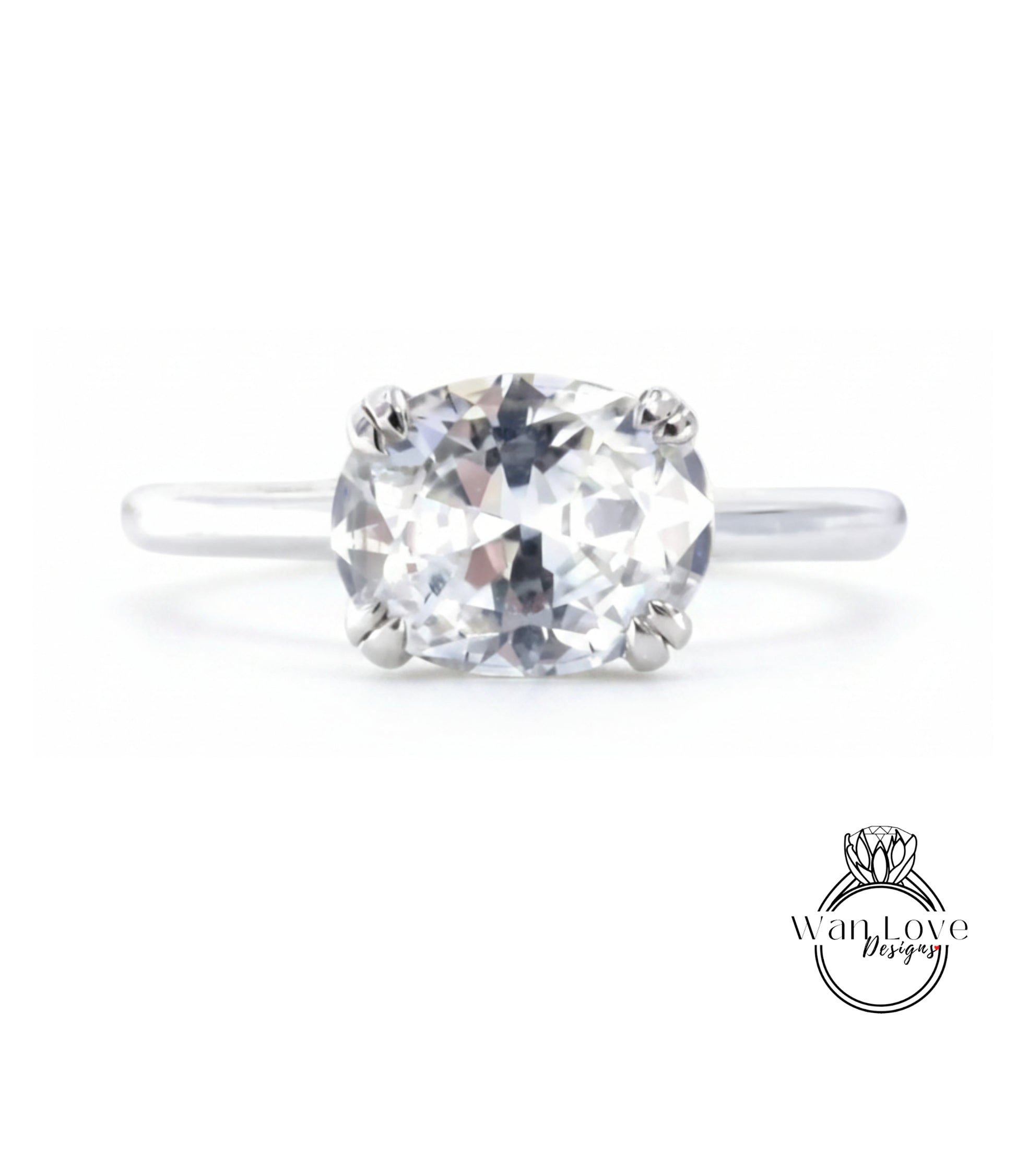 A close-up view of a diamond engagement ring with a large, clear gemstone set in a silver band.