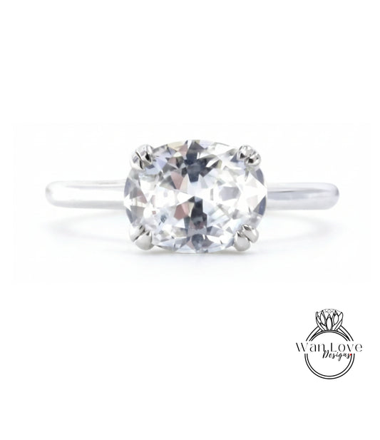 A close-up view of a diamond engagement ring with a large, clear gemstone set in a silver band.