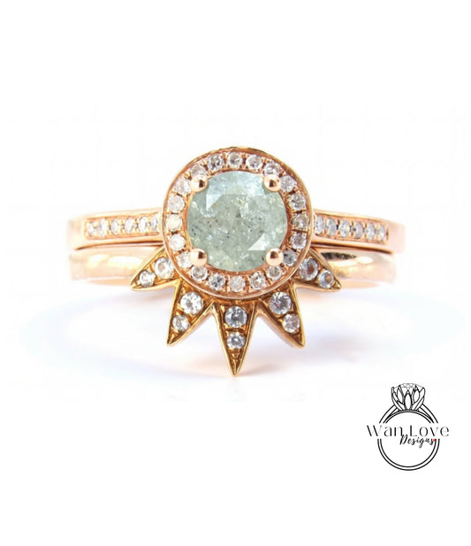 A gold ring with a large, light green diamond at the center, surrounded by smaller diamonds and set in a halo-like design.