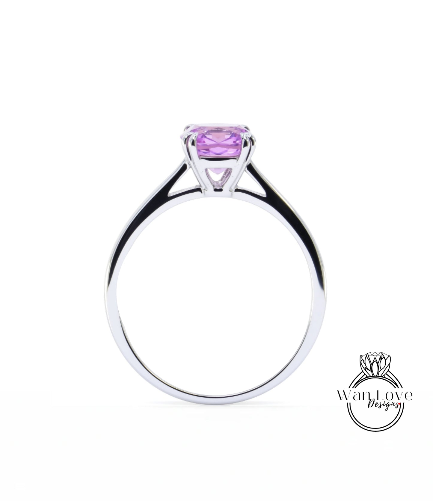 A silver ring with a large purple gemstone, likely a sapphire, set in the center.
