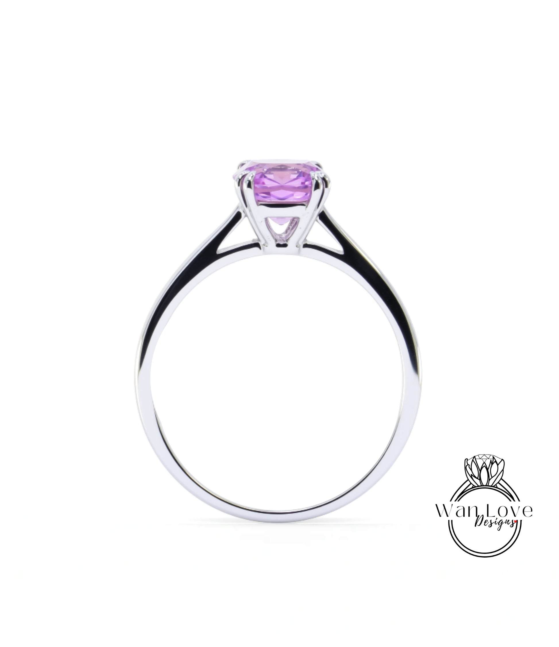 A silver ring with a large purple gemstone, likely a sapphire, set in the center.