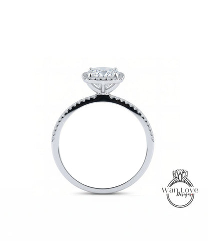 A silver engagement ring with a large central diamond and a halo of smaller diamonds around the top.
