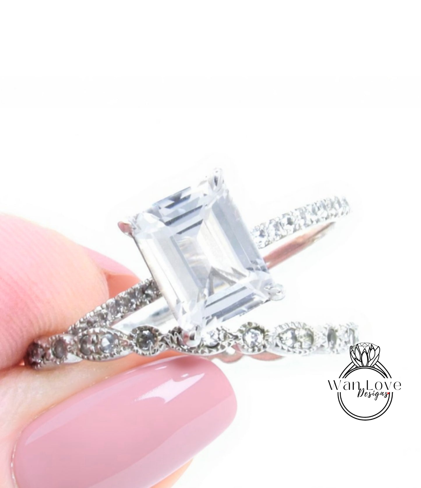A close-up of a person's hand holding a diamond engagement ring with a large, clear gemstone set in a silver band.