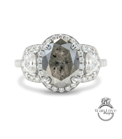 A diamond engagement ring with a large oval-shaped diamond at the center, surrounded by smaller diamonds and set in a halo of smaller diamonds.